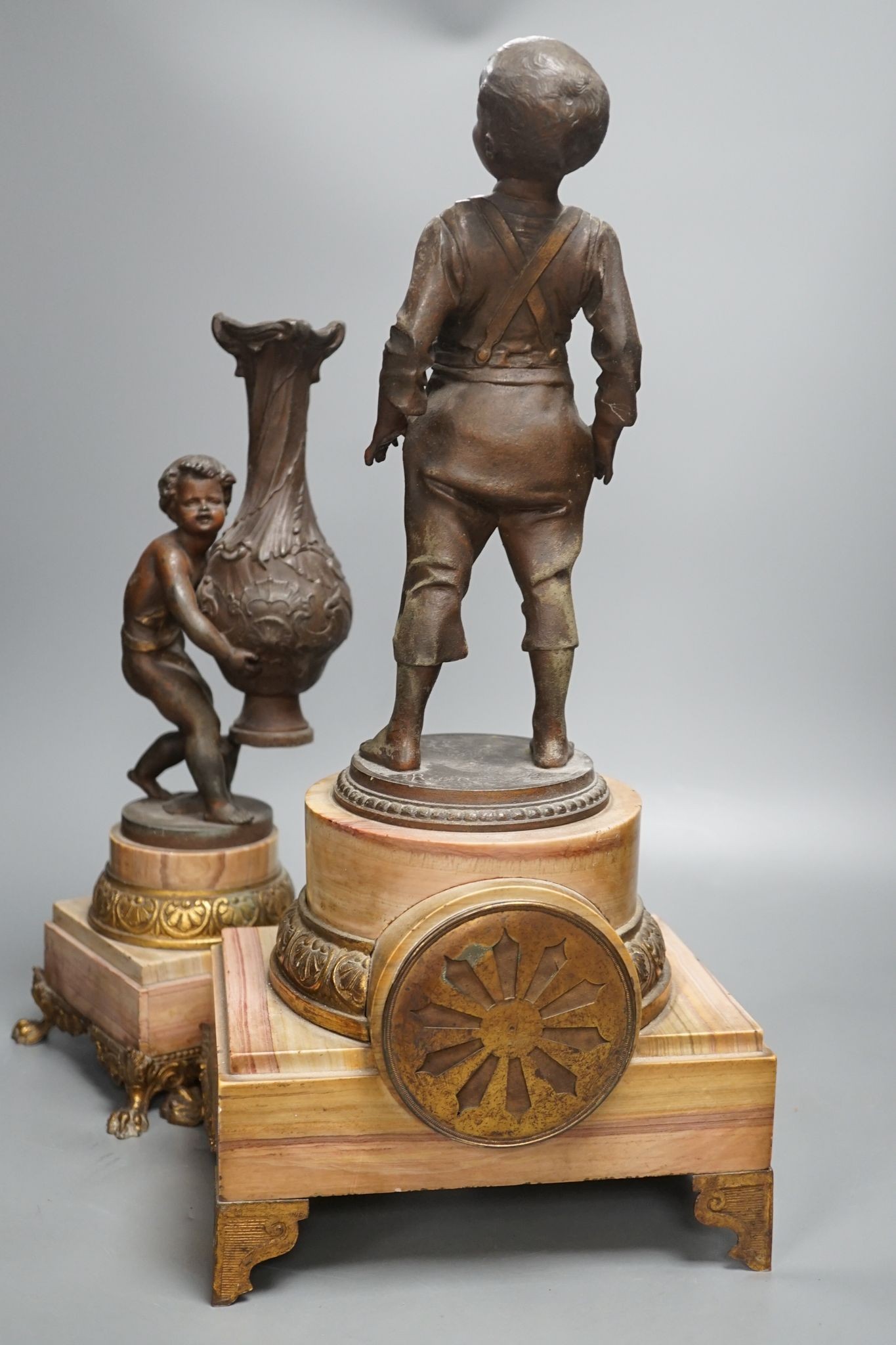 A spelter and marble figural mantel clock and a matching vase 47cm